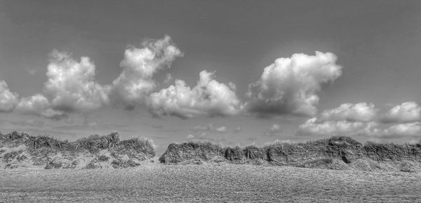 Panoramic view of field against sky