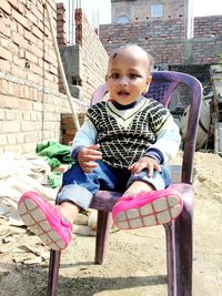 Portrait of cute girl sitting outdoors