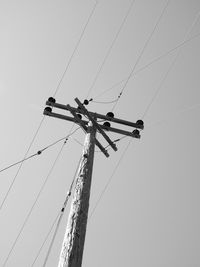 Low angle view of electricity pylon against sky