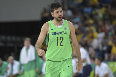 Man with arms raised against blurred background