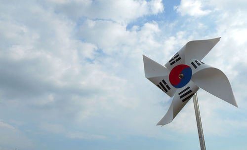 Low angle view of road sign against sky