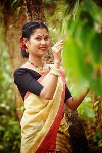 Portrait of smiling young woman standing outdoors