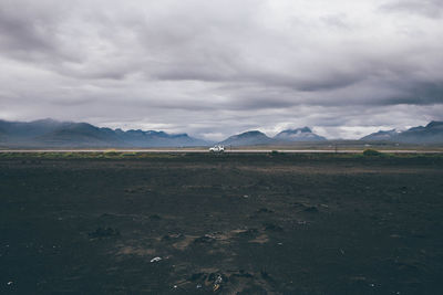 Scenic view of mountains against cloudy sky