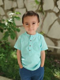 Portrait of cute boy standing outdoors