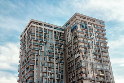 Low angle view of building against cloudy sky