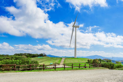 Windmill on field against sky