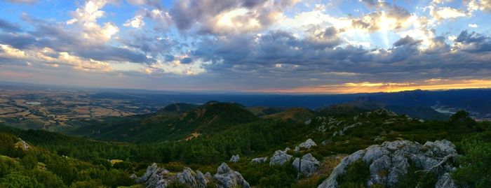 Scenic view of mountains against cloudy sky