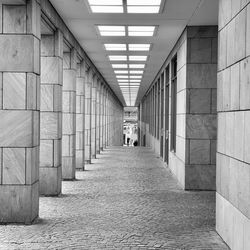 Rear view of people walking in corridor of building