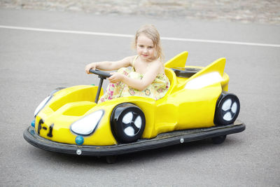 Portrait of cute girl sitting in car