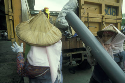 Rear view of people working at construction site