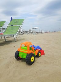 Toy toys on beach against sky