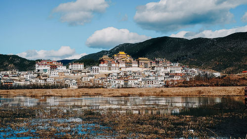 Buildings in town against sky