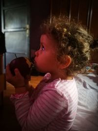 Side view of a girl eating food