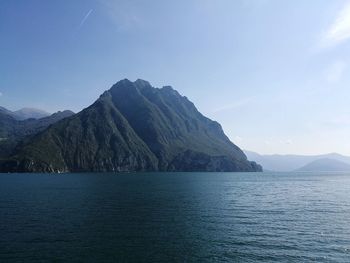 Scenic view of sea and mountains against sky