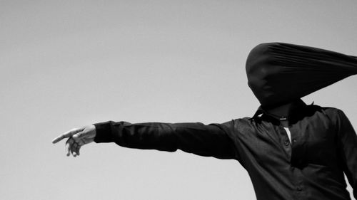Low angle view of man against clear sky
