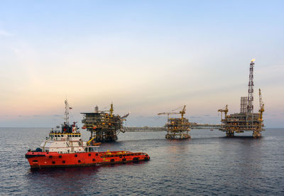 Anchor handling tugboat maneuvering while performing anchor deployment at platform vicinity