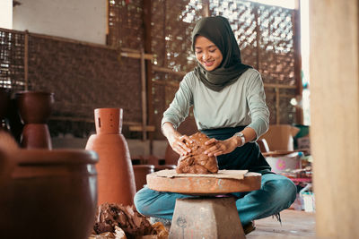 Portrait of young woman preparing food in workshop