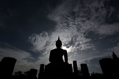 Low angle view of silhouette statue against sky during sunset