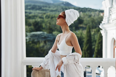 Woman looking at white window