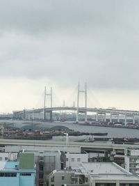 View of suspension bridge against cloudy sky