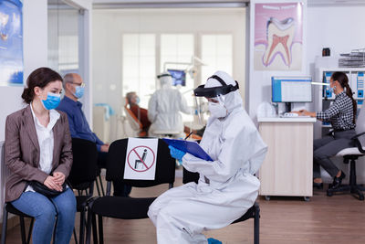 Doctor consulting female patient at hospital