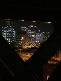 Low angle view of illuminated ferris wheel