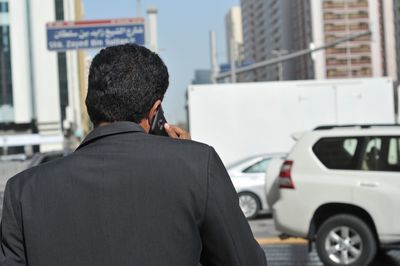 Rear view of a man standing in city