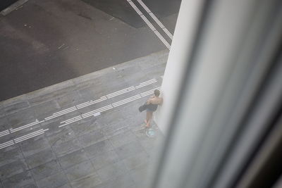 High angle view of man walking on street