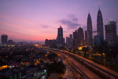 Buildings in city against sky during sunrise