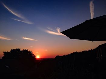 Silhouette landscape against sunset