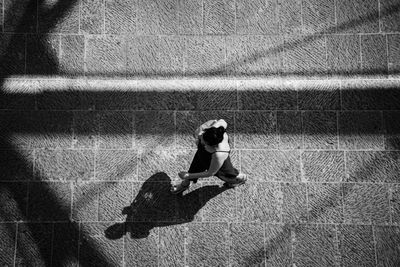 High angle view of woman walking on footpath