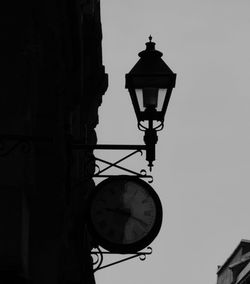 Low angle view of street light against building