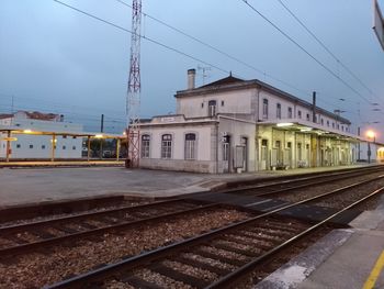 Train at railroad station against sky