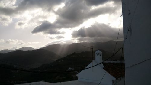 Scenic view of mountains against cloudy sky