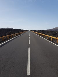 Surface level of empty road against sky