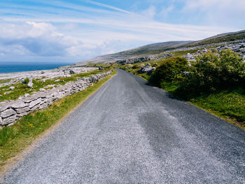 Road by sea against sky