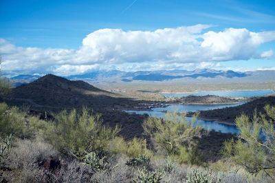 Scenic view of lake and mountains against sky