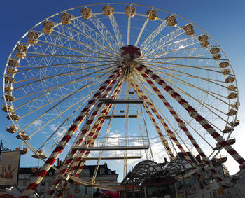 Low angle view of ferris wheel against sky