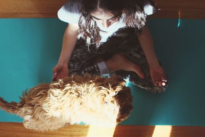 Midsection of woman with dog at home