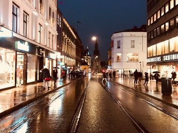 People in illuminated city at night