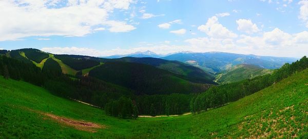 Scenic view of mountains against cloudy sky