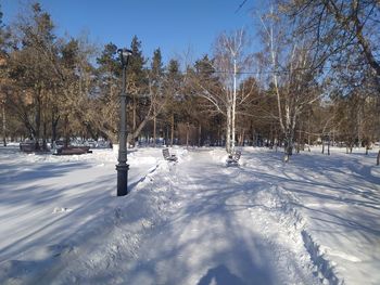 Snow covered field against sky, embankment on a winter morning