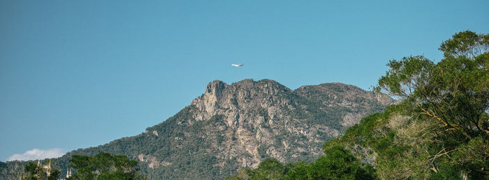 Low angle view of mountain against blue sky