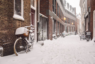 Man riding bicycle on street in city during winter