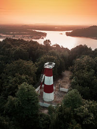 High angle view of building by trees against sky during sunset