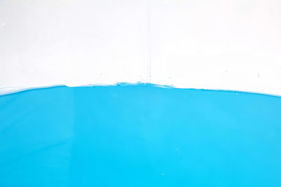 Close-up of blue water against wall