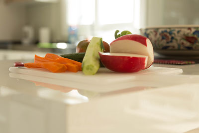 Various vegetables on cutting board in kitchen