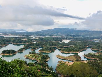 Scenic view of lake against sky, guatape, colombia