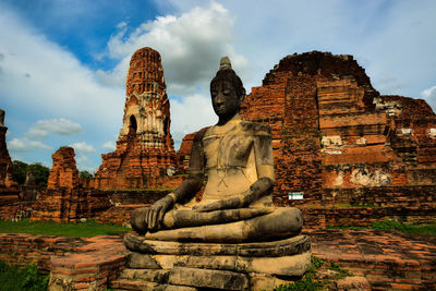 Statue of temple against cloudy sky