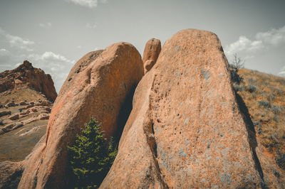 Low angle view of rock formations against sky